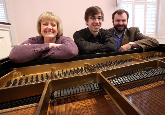 pianist Alexander Cap with two others in front of piano