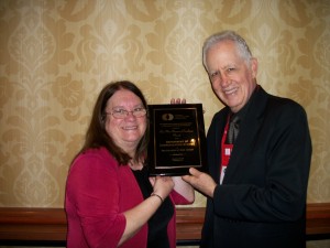 Dr. John Pollock accepting the Rex Smith Program of Excellence Award presented by Dr. Armeda Reitzel