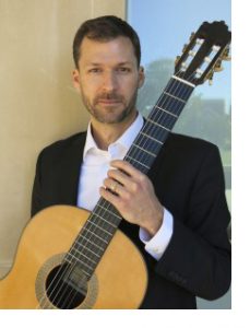 Dr. James Day posing with acoustic guitar