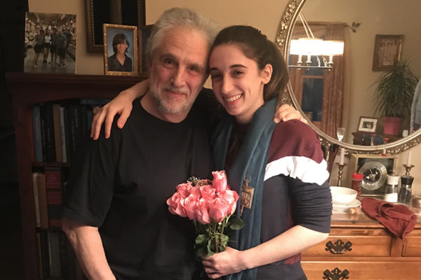 Julia Corso posing with family and flowers