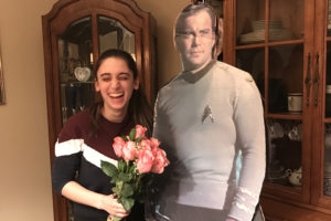 Julia Corso laughing with captain kirk cardboard cutout and flowers