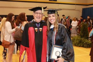 woman graduate pictured with male professor