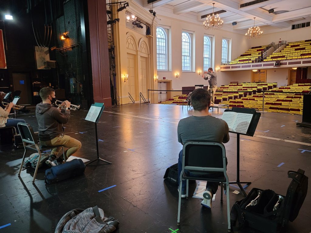 trumpet students rehearsing on stage in empty theater