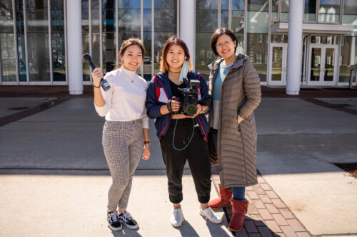 three women posing outside