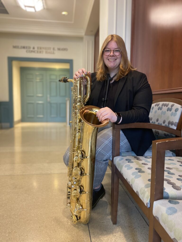 Photo of student holding saxophone