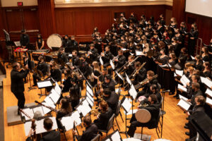 TCNJ Wind Ensemble and Choirs perform on the stage of Mayo Concert Hall.