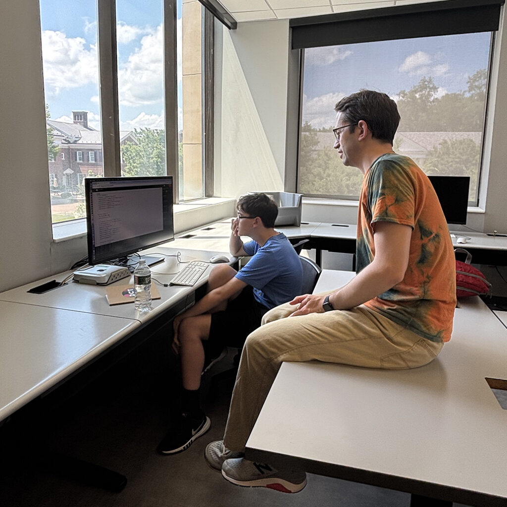 Faculty and student at game design camp